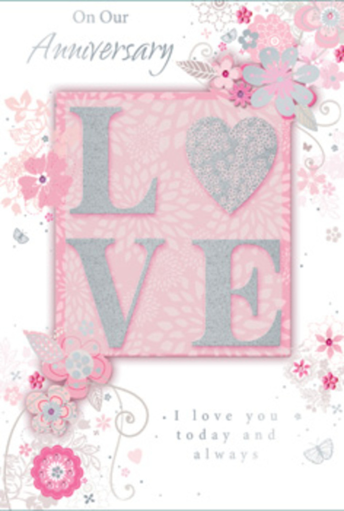 The anniversary card in this image looks like a soft whisper of love captured on paper, its gentle colours and floral curls echoing the romantic bouquets often requested in Barking for milestone celebrations. Dominating the centre is the word LOVE, printed in large, raised letters that seem to float above the surface, each stroke edged with fine, glittery highlights. The texture appears slightly grainy yet smooth to the touch, inviting a slow, appreciative fingertip trace the way one might follow the curve of a rose stem. Behind and around these letters lies a field of delicate illustration: hand-drawn flowers in blush pink and creamy white, with stylised petals that open outward in graceful arcs. Their details are picked out with pale grey and silver lines, suggesting soft shadows and the gentle sheen of satin ribbon used in professional arrangements. Curving vines and leaves weave between the blooms, looping and swirling as though a florist's pencil has danced freely across the page, reminiscent of sketches done at a workbench just off Ripple Road. The background is a soothing wash of pastel pink, not flat but subtly shaded, creating a sense of depth without overwhelming the design. Tiny flourishes and filigree curls appear here and there, like faint echoes of butterflies or drifting petals. An anniversary message, written in an elegant, flowing script, rests harmoniously beneath or alongside the central motif, its wording affirming enduring love-perfect for couples who have shared years together in Barking, from walks through Barking Park to cosy evenings at home. The overall effect is one of refined sentiment, an ideal companion to an anniversary bouquet thoughtfully prepared and delivered by Florist Barking.